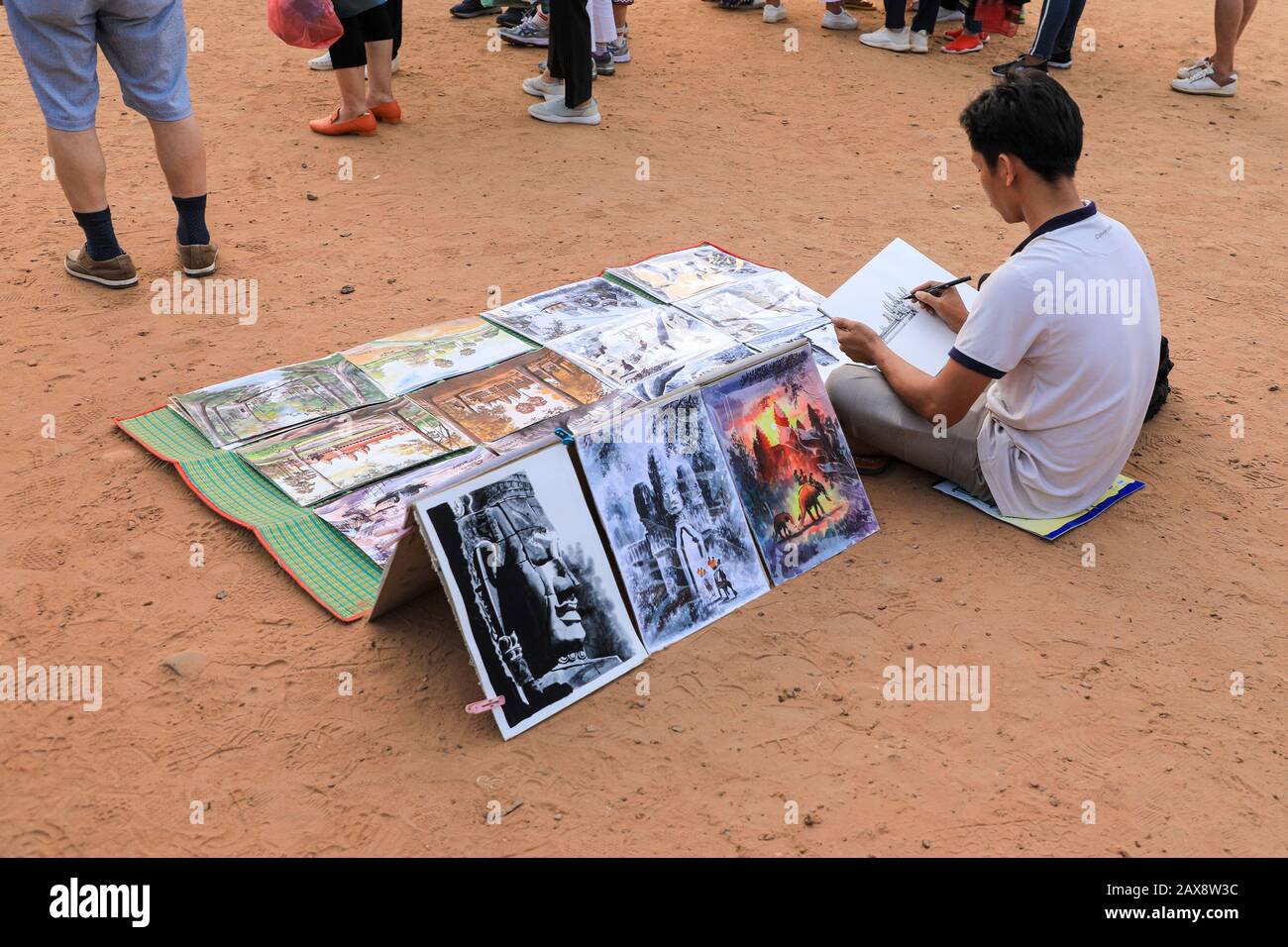 An artist drawing the temple at Angkor Wat and selling his drawings and paintings, Angkor Wat, Cambodia, Asia Stock Photo