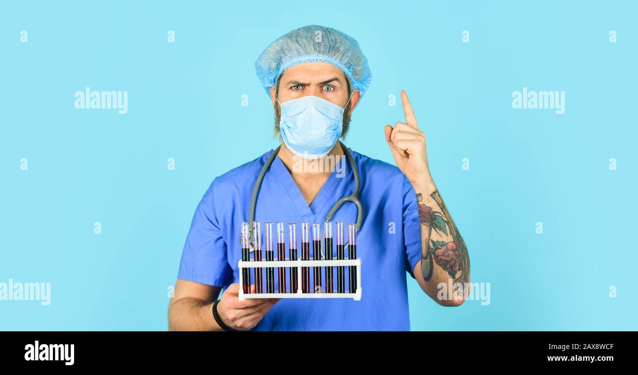 Quarantine plans. Epidemic threshold. Medical research. Man in medical lab inspecting samples biological material. Test tubes. Epidemic disease. Virus concept. Epidemic infection. Hospital treatment. Stock Photo