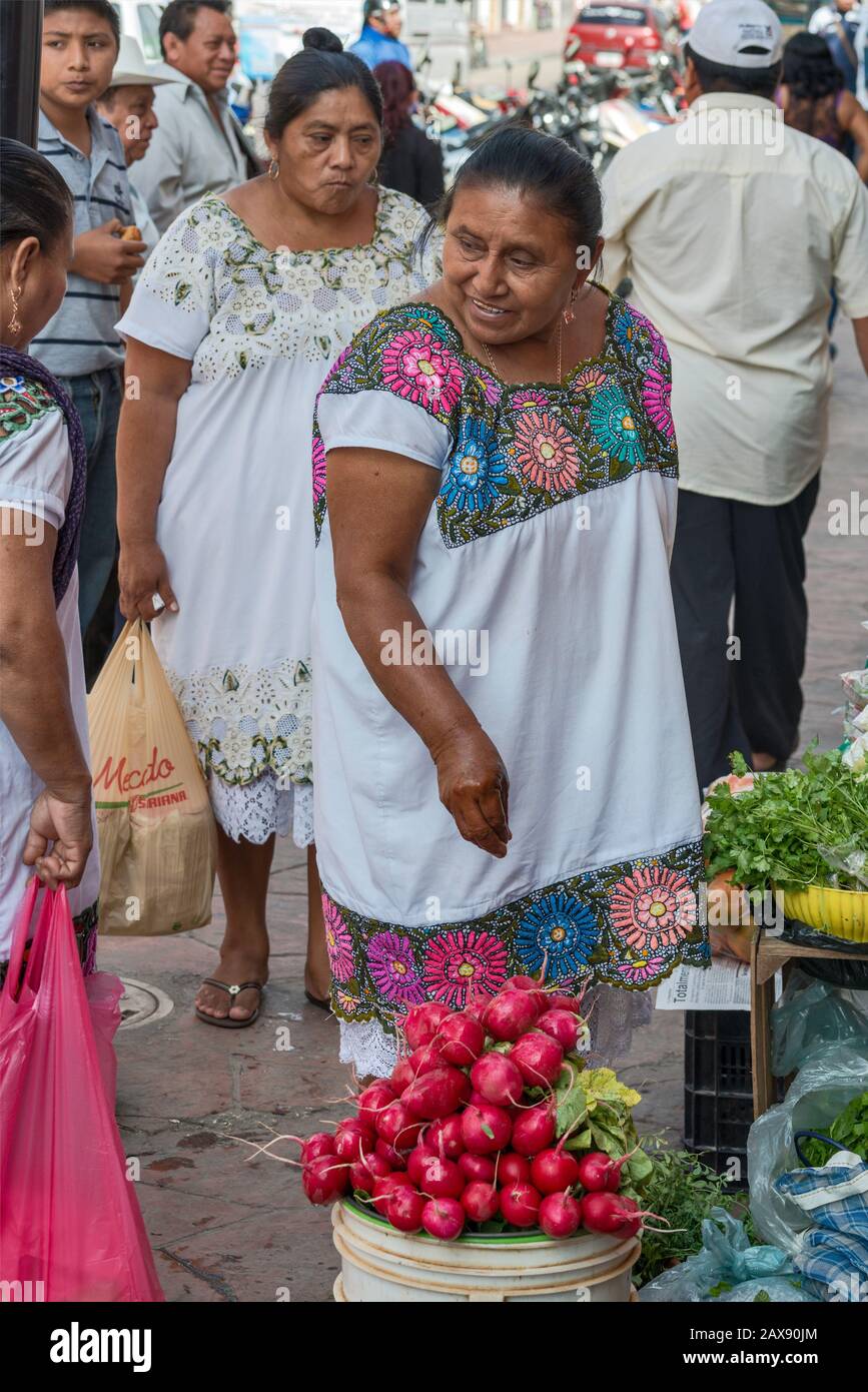 Woman selling vegetables, wearing huipil, traditional hand-embroided Mayan dress, at Calle 44 in Valladolid, Yucatan state, Mexico Stock Photo