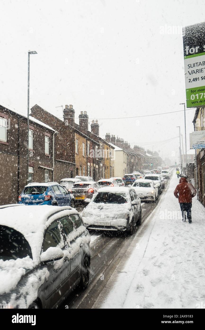 Heavy traffic on Anchor road due to a sudden snow blizzard in Stoke on Trent, dangerous driving conditions, cars travelling slowly, safely Stock Photo