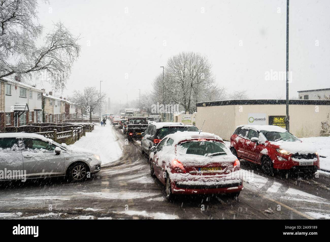 Heavy traffic on Anchor road due to a sudden snow blizzard in Stoke on Trent, dangerous driving conditions, cars travelling slowly, safely Stock Photo