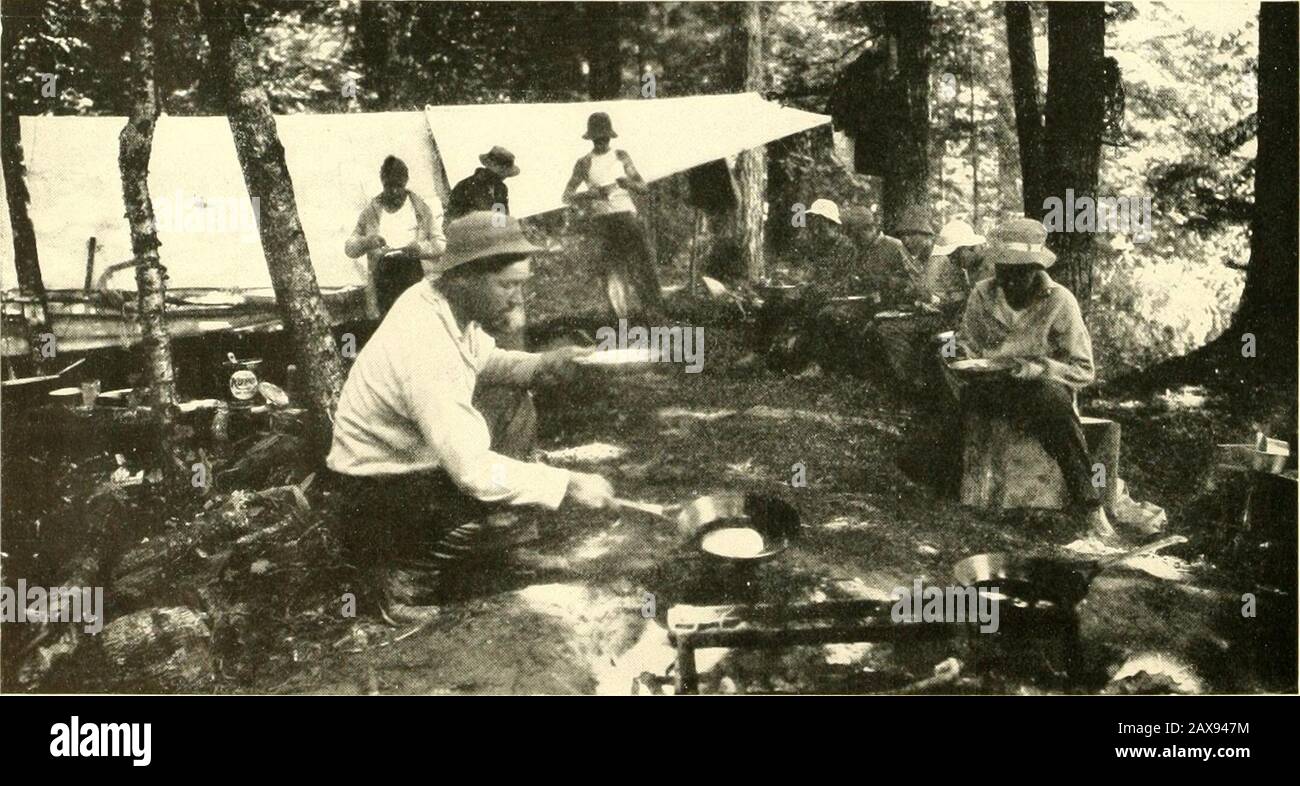 Lakes and resorts of the northwest; . JUST THE PLACE FOR TROUT. A CAMPERS KITCHEN IN THE COOL NORTH WOODS16 REACHED B Y C H I C A G 0 AND N O R T II ]] E S T E R N R Y. Lac Vieux Desert, Wis.—(Contd)group of innumerable lakes and water courses, placed in .1magnificent setting of virgin forests, in which State LineWatersmeet, Cisco Lake and Gogebic are located. FmmState Line the famous fishing grounds at Lac Vieux Desertare reached by a five-mile drive east through the pines.This beautiful resort is famous for the muskellunge andwall-eyed pike found abundantly here. Hotels and BoardingHouses Pr Stock Photo