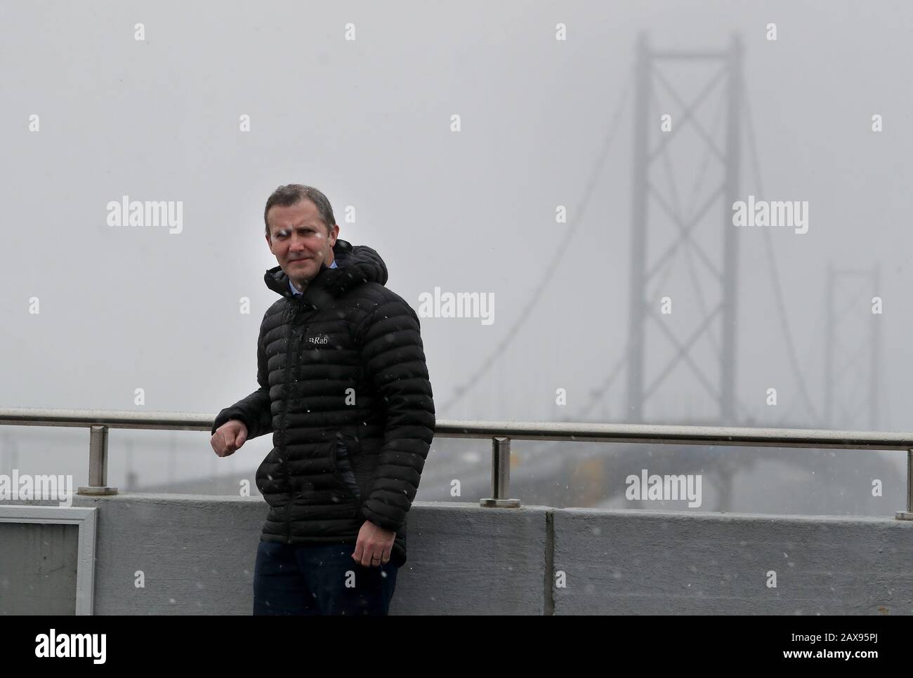 Transport Secretary Michael Matheson with the Forth Road Bridge in the background during a visit to the control centre at the Queensferry Crossing, South Queensferry. PA Photo. Picture date: Tuesday February 11, 2020. Crossing operators Amey closed the key route until further notice as a safety precaution due to ice falling from the cables. Eight cars were damaged in severe weather on Monday. See PA story WEATHER Storm Scotland. Photo credit should read: Andrew Milligan/PA Wire Stock Photo