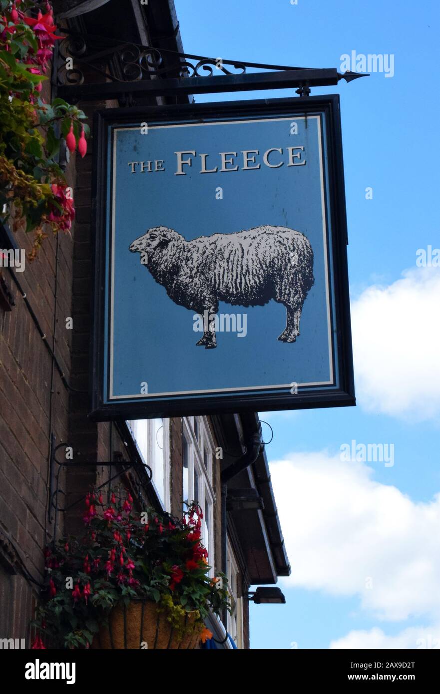 INN SIGNS  - The Fleece in Whitby, North Yorkshire, UK. Pub signs date from a time when their customers were often illiterate, but could recognise pictorial images. The Fleece as a pub name  is said to have evolved from hostels owned by the 15th century Knights of the Order of the Golden Fleece in Medieval times and later . (King Henry VIII of England was a member of the Order, so many of the pubs with this name may have had connections with the monarch).Another source of pubs with this name occurs in rural areas where a sheep's fleece was hung out by innkeepers when a new brew was available. Stock Photo