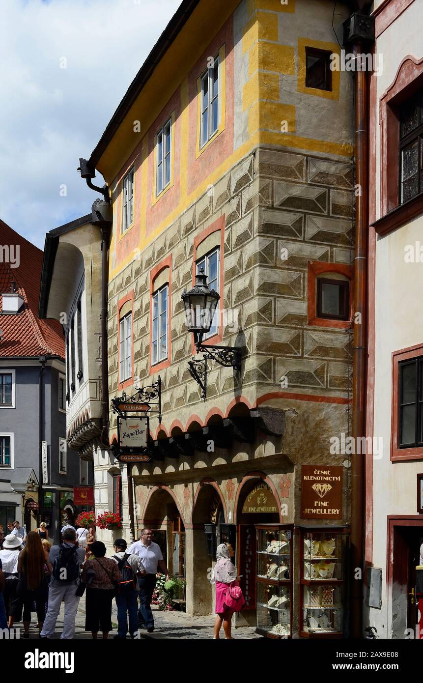 Cesky Krumlov, Czech Republic - August 11th 2013: Unidentified tourists in a small street and house with sgraffito decorated facade in the Unesco Worl Stock Photo