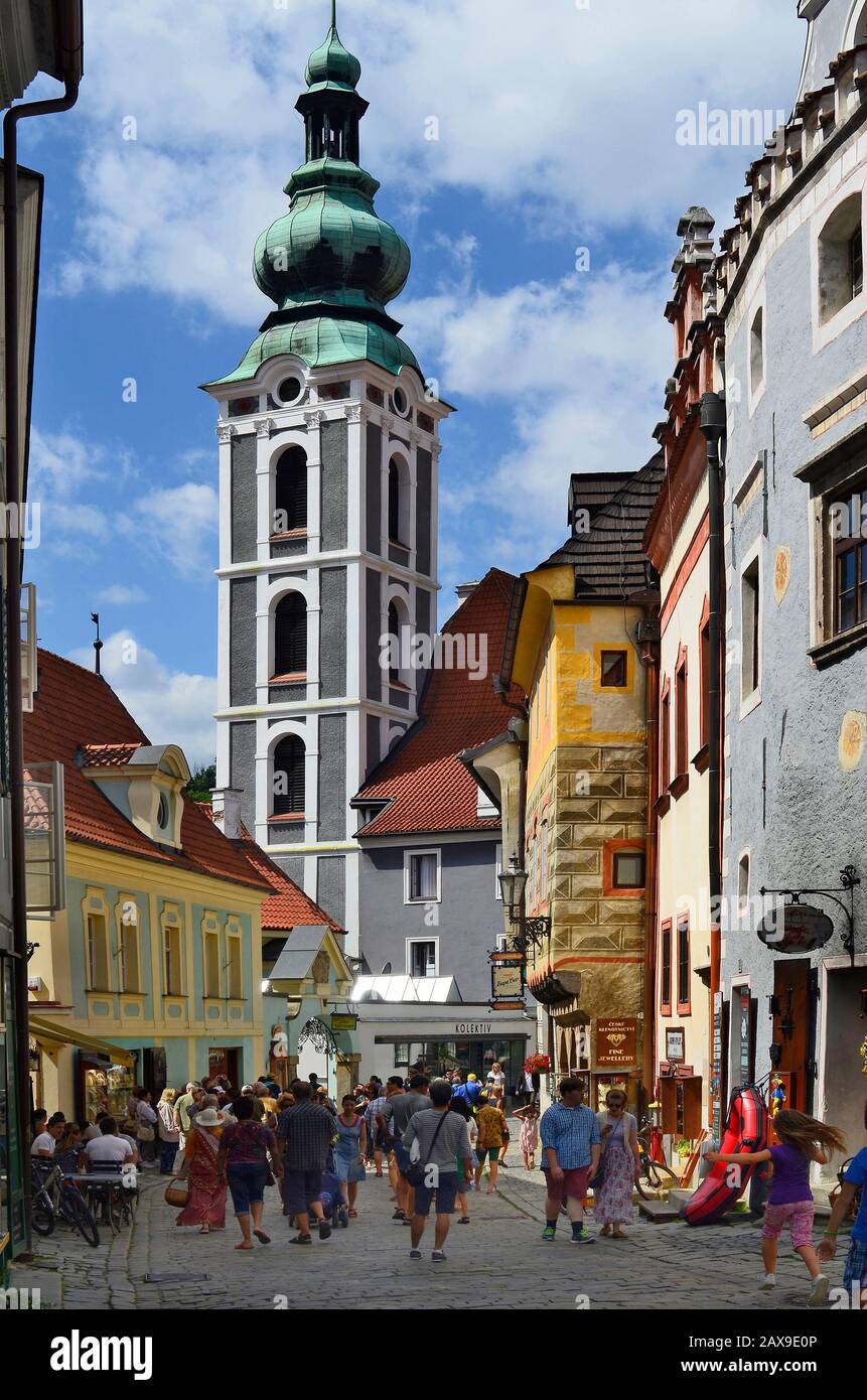 Cesky Krumlov, Czech Republic - August 11th 2013: Unidentified tourists in a small street with different shops, house with sgraffito decorated facade Stock Photo