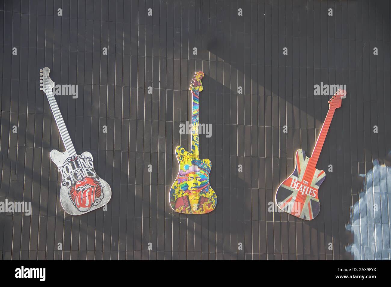 Home facade wall decoration by replica of 3 guitars, Rolling Stones, Jimmy Hendrix, The Beatles Stock Photo