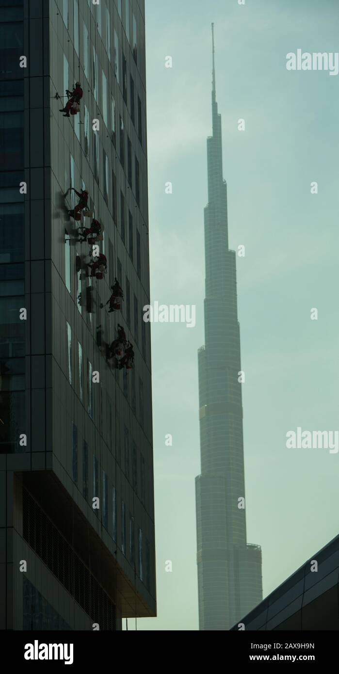 Window Cleaners and Burj Khalifa in background, Dubai, United Arab Emirates. Stock Photo