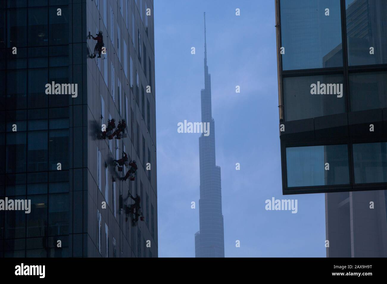Window Cleaners and Burj Khalifa in background, Dubai, United Arab Emirates. Stock Photo
