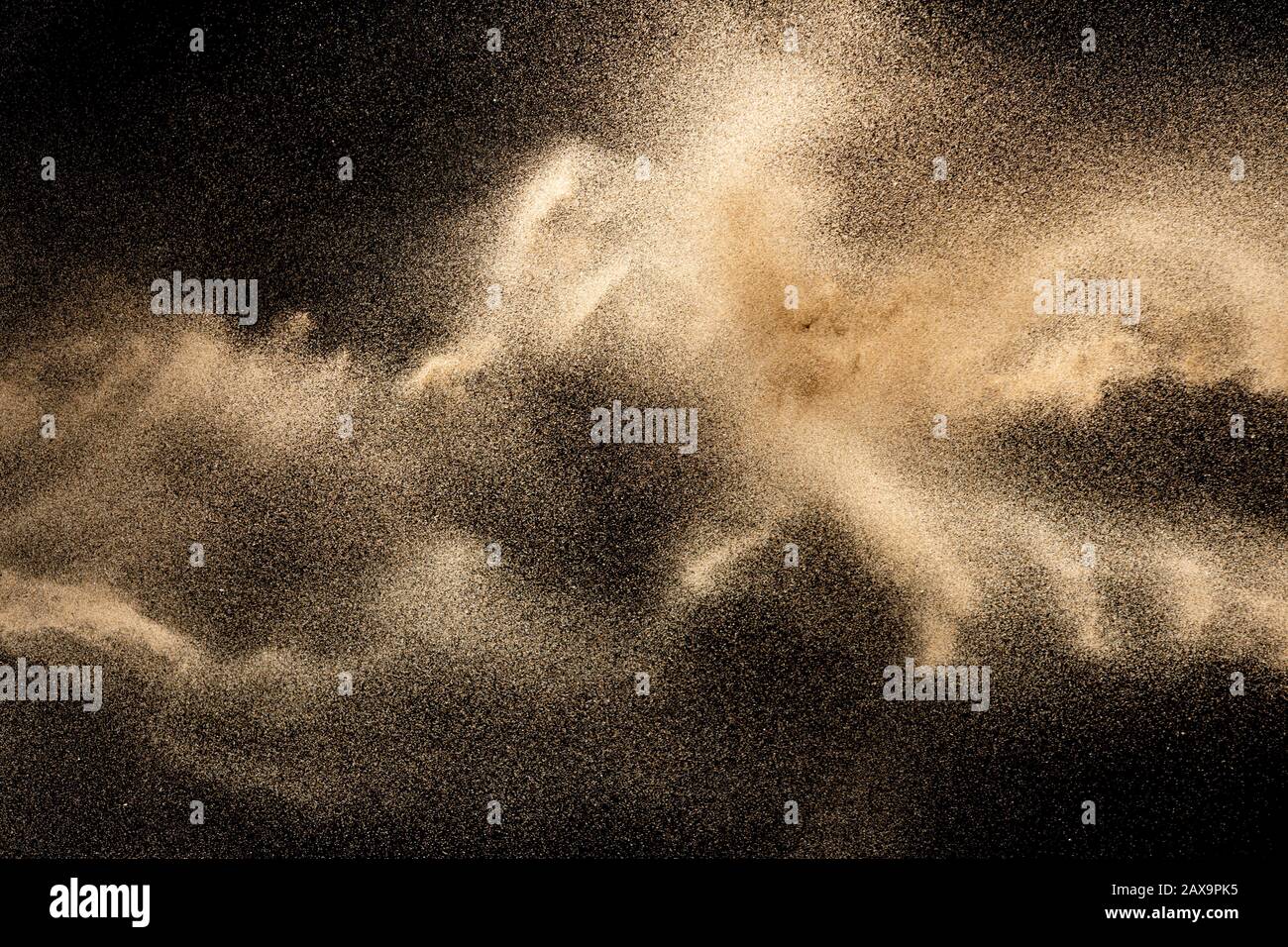 Brown colored sand splash.Dry river sand explosion isolated on black background. Abstract sand cloud. Stock Photo