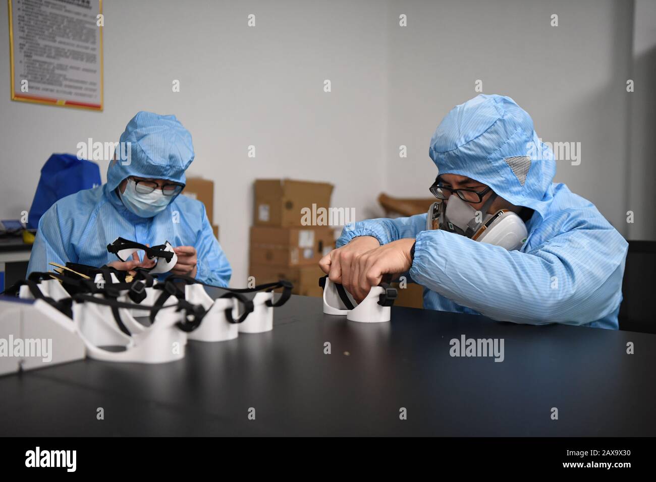 (200211) -- CHANGSHA, Feb. 11, 2020 (Xinhua) -- Workers produce goggles at the additive manufacturing research and application center of Hunan Vanguard Group Co., Ltd. in the economic development zone of Changsha City, central China's Hunan Province, Feb. 11, 2020. The company has been producing goggles for medical use with more than 50 3D printers working day and night recently. The first batch of 500 pairs of goggles it produced have been sent to Changsha and Huaihua to aid the novel coronavirus control efforts there. (Xinhua/Xue Yuge) Stock Photo