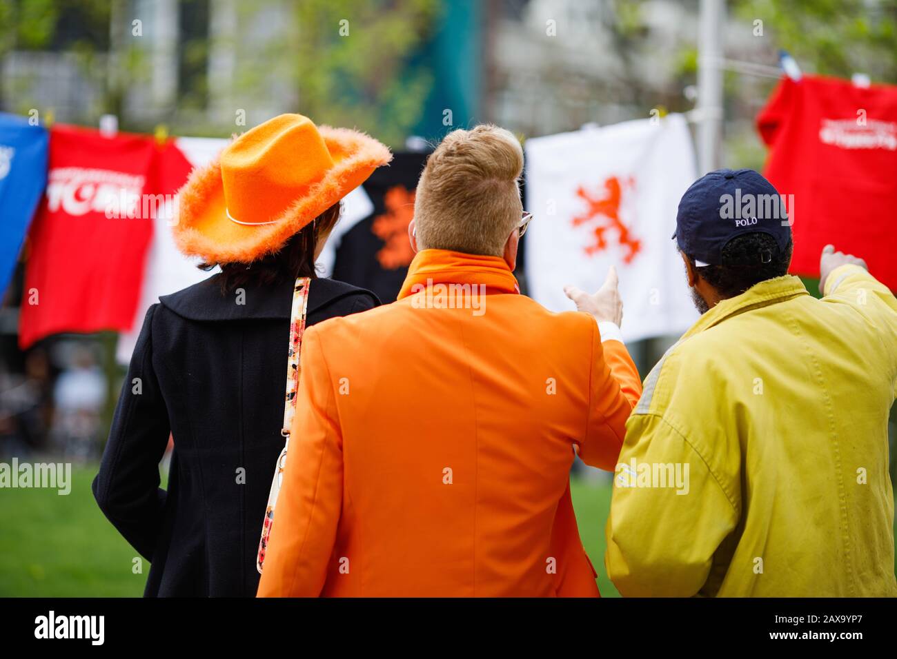 3 caucasian dutch men celebrating koningsdag in Amsterdam Stock Photo