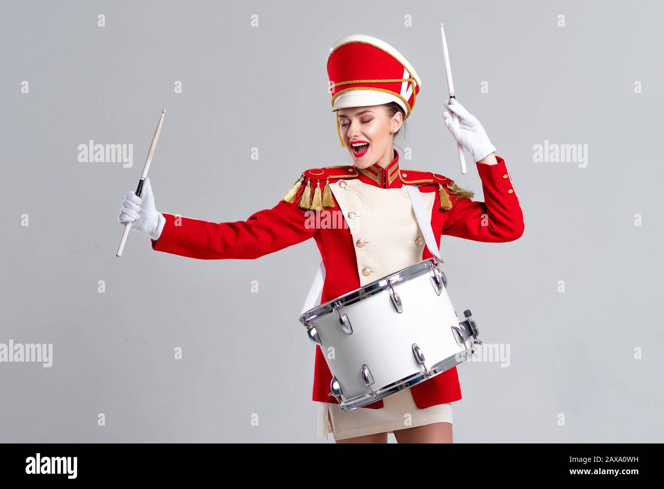 Drummer in a red uniform drums on a drum, show program and celebration ...