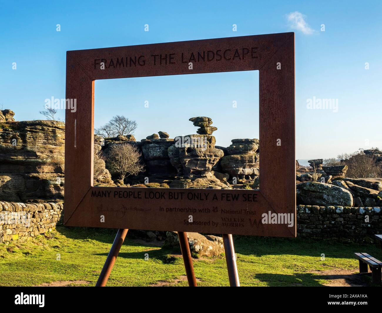 Rusty metal frame and gritstone rock formations at Brimham Rocks Brimham Moor Nidderdale AONB North Yorkshire England Stock Photo