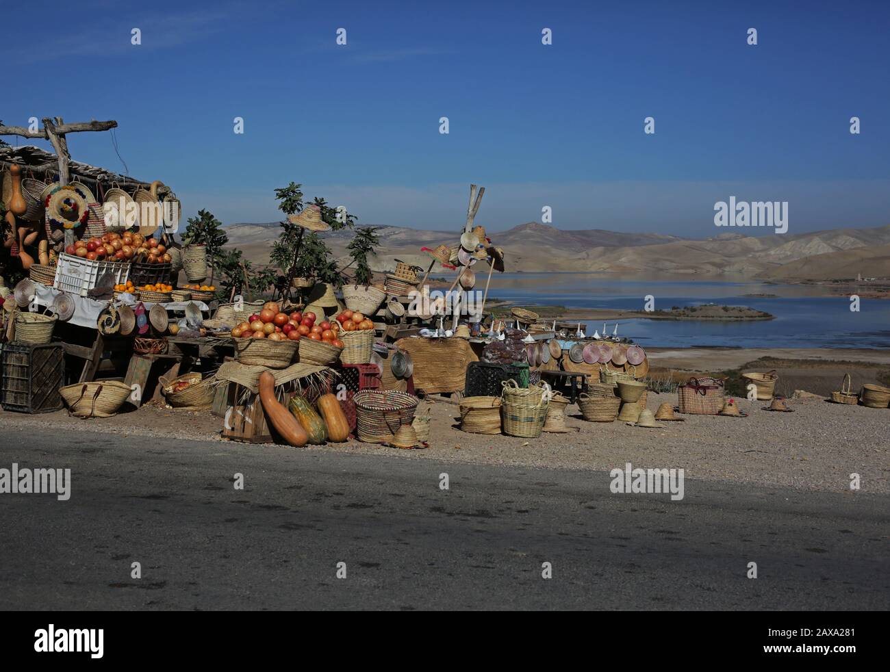 Pumpkins and persimmon fruits are pictured for sale at a roadside stall alongside the Sidi Chahed dam reservoir pictured outside Fez in Morocco. Stock Photo