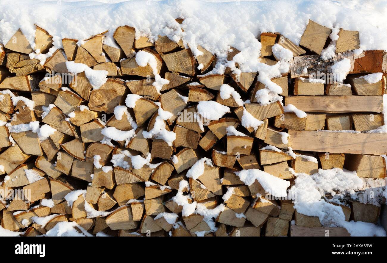 logs of wood in a pile ready to be cut and chopped for firewood in a  fireplace and boiler Stock Photo - Alamy