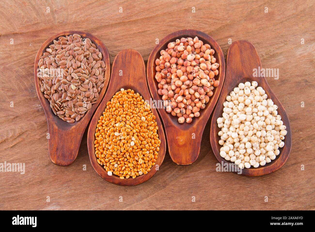 sorghum, millet and flaxseed in spoon. Stock Photo