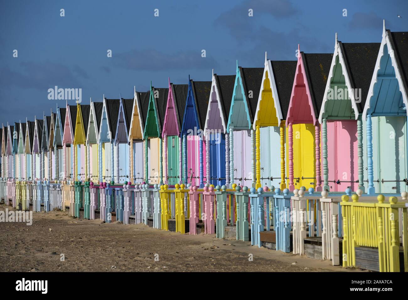 Brightly-coloured beach huts on Mersea Island, Essex, as, elsewhere in the UK, rain and wind caused by storm Ciara gave way to hazardous amounts of snow and ice. Stock Photo