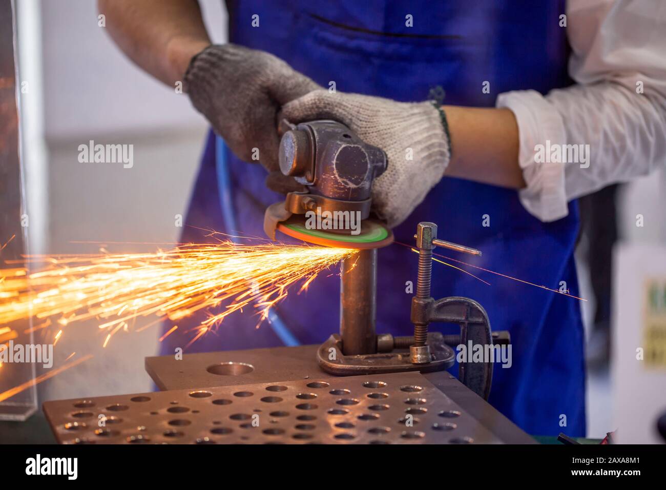 Roofer using a angle grinder to cut a metal. Stock Photo
