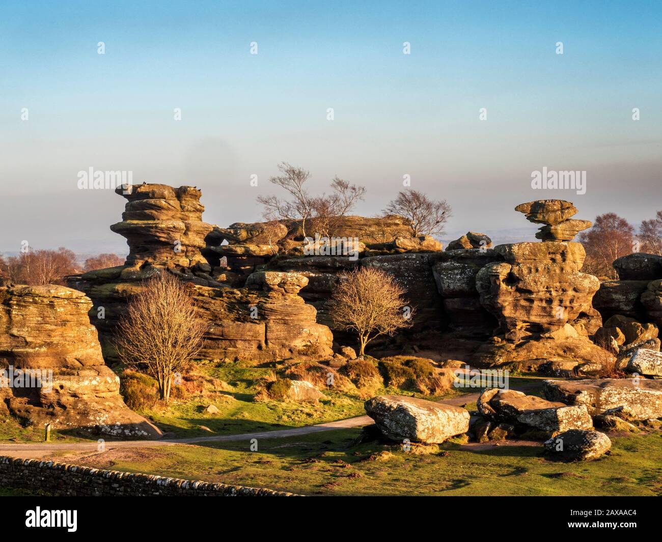 Gristone rock formations lit by the setting sun on a winter afternoon at Brimham Rocks Brimham Moor Nidderdale AONB North Yorkshire England Stock Photo