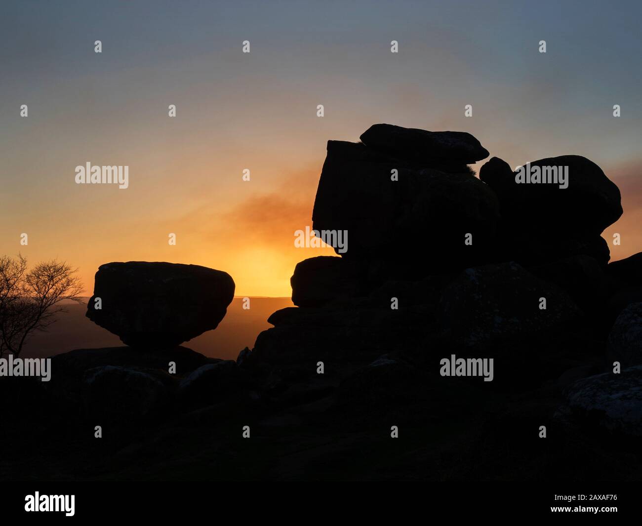 Gristone rock formations silhouetted against a sunset sky at Brimham Moor Nidderdale AONB North Yorkshire England Stock Photo