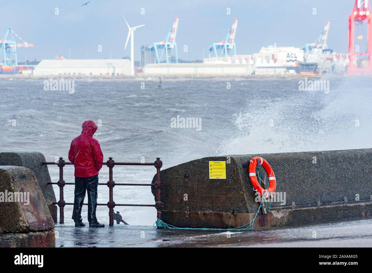 New Brighton, Wirral, UK. 11th February 2020. A man braves the River Mersey as the aftermath of Storm Ciara continues to hit New Brighton, on the Wirral peninsula.  With strong gale force winds and flooding, the cleanup operation now begins.  Credit: Paul Warburton/Alamy Live News Stock Photo