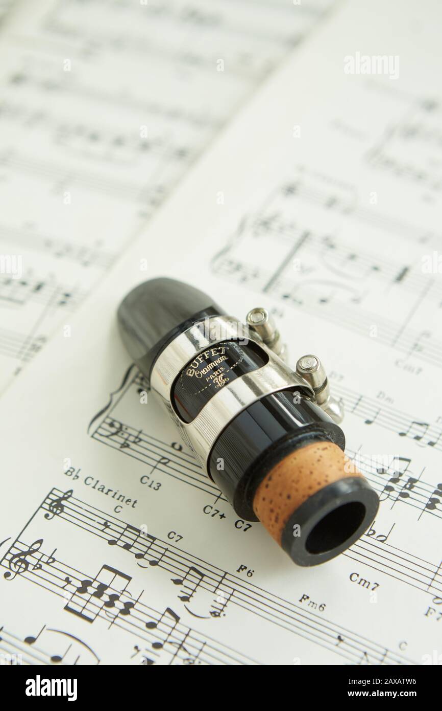 A photograph of a Buffet Crampon mouthpiece lying on sheet