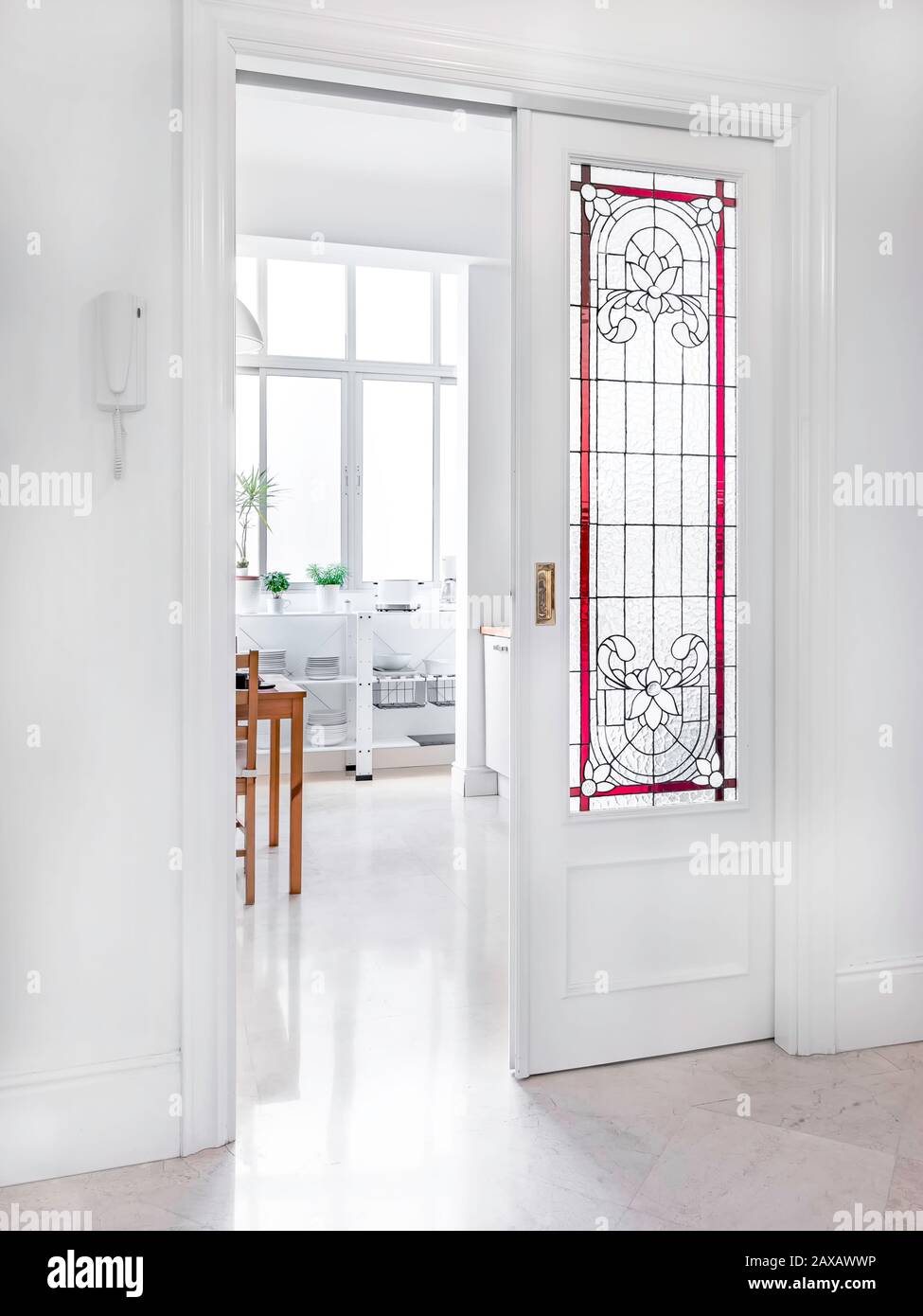 Lobby room in the entrance of a modern apartment with stained glass doors. Bright hall in a elegant interior with a golden wooden mirror Stock Photo