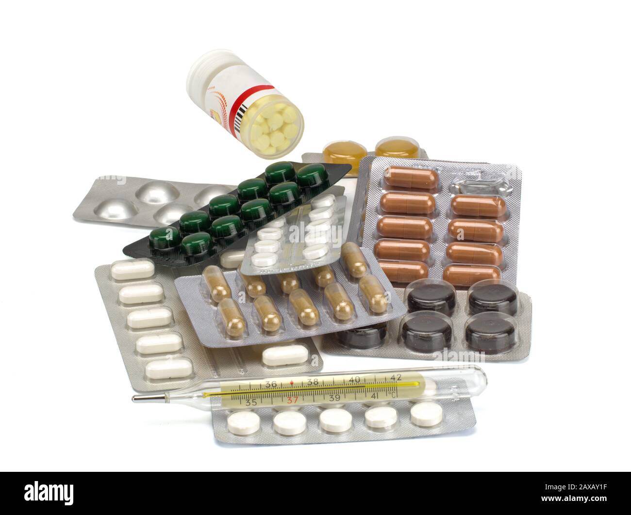 Different tablets, pills in foil blister packs, medications drugs and thermometer on white background Stock Photo