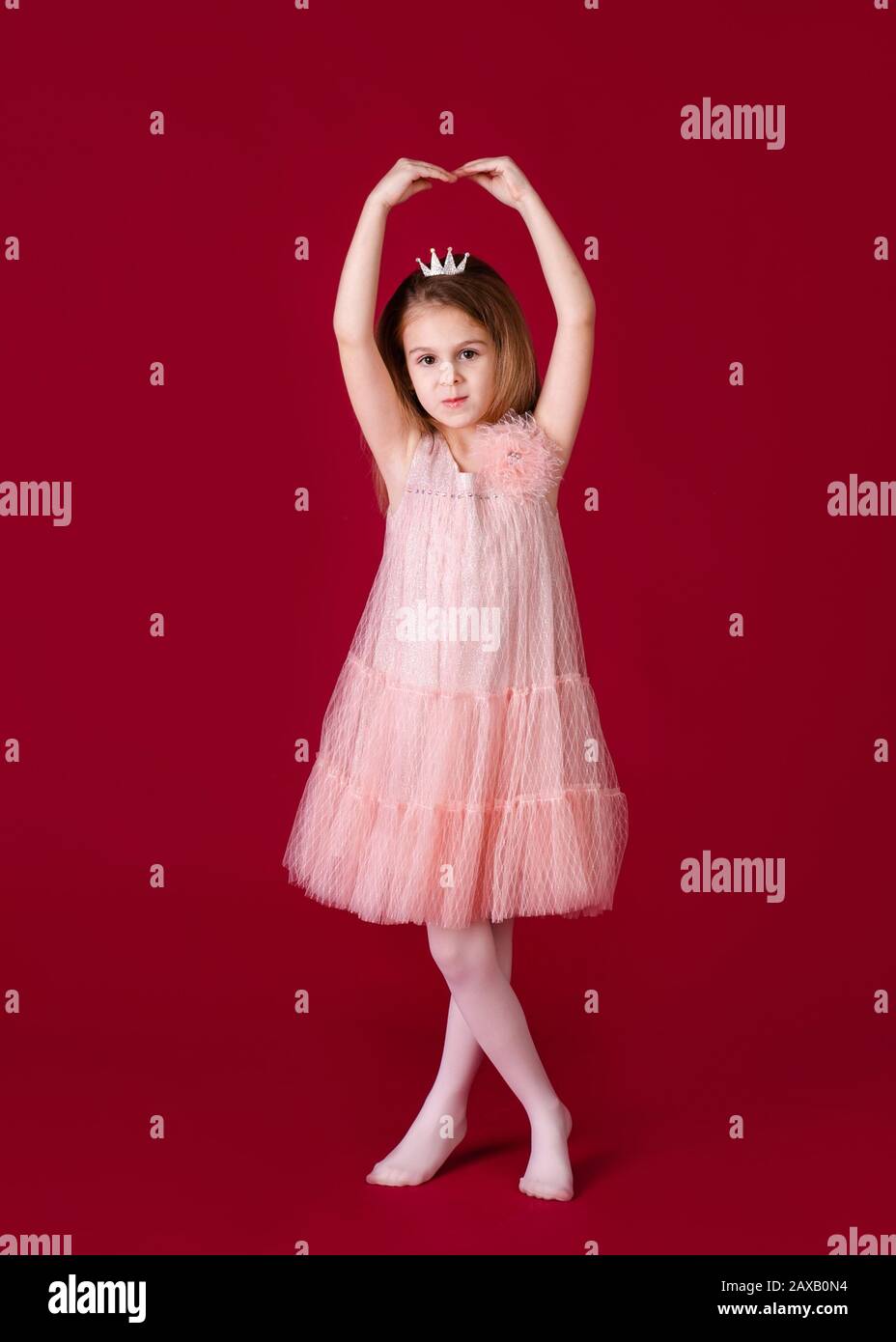Beautiful little girl princess dancing in luxury pink and silver dress ...