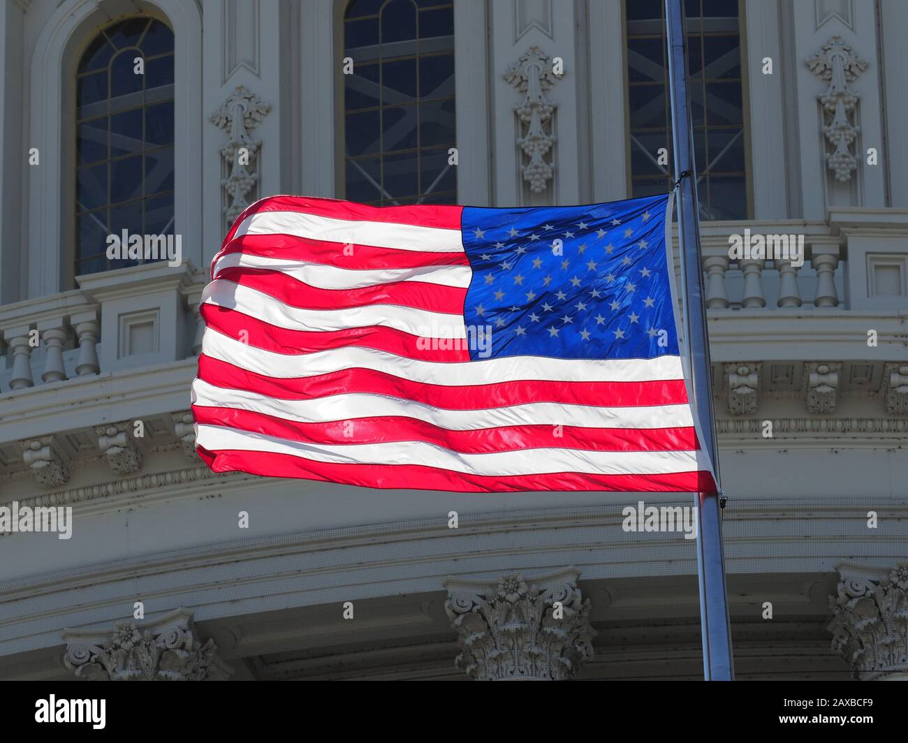 American flag halfmast on top of the capitol Stock Photo Alamy