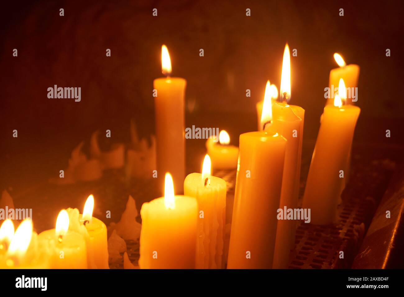 Lots of lit candles light up a dark cave Stock Photo Alamy