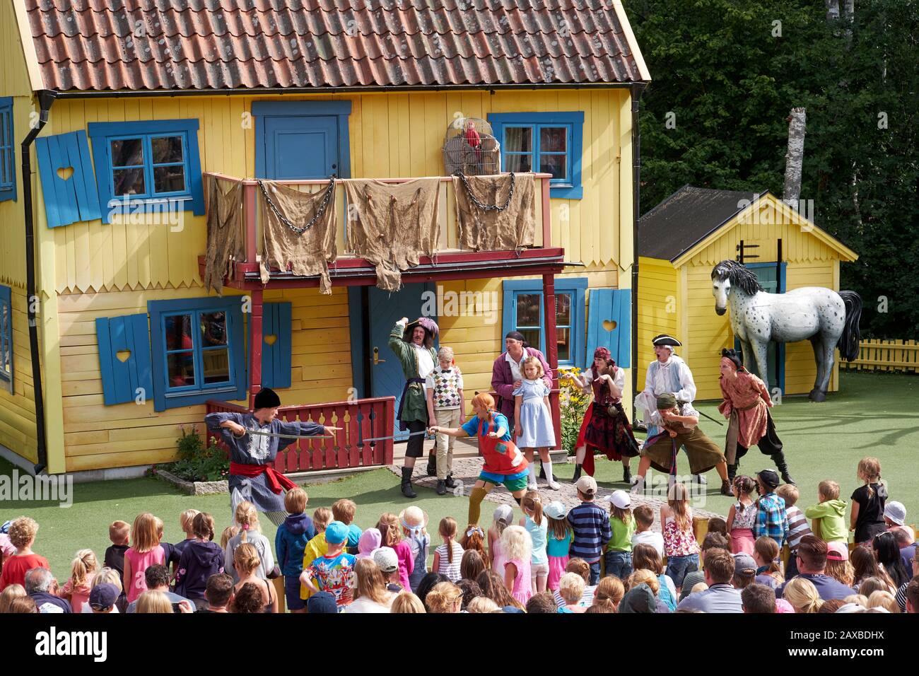 Live show of Pippy Longstocking at Astrid Lindgren's World showing the actors performing to a mixed audience with Villa Villekulla as decor. Stock Photo