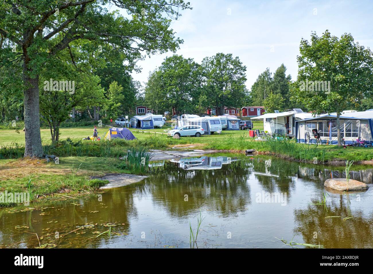 Swedish campsite with pond, caravans and holiday chalets Stock Photo