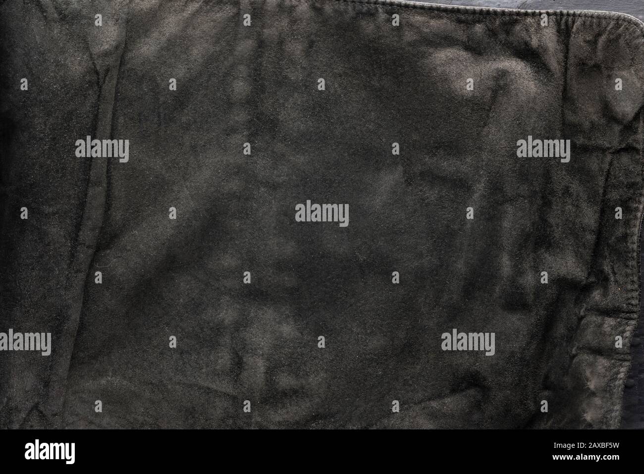 black structural background - old shabby stylish suede, reverse side, old fabric, textile. Stock Photo