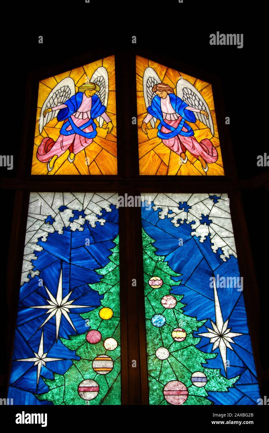 Christmas Tree and Angels in a beautiful Stained Glass Window in the Christmas Shoppe located in
