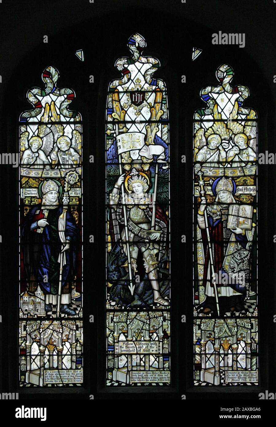 A stained glass window by C E Kempe & Co. Ltd. depicting Saints Martin of Tours, Michael Archangel & Dunstan, All Saints Church, Braunston, Rutland Stock Photo