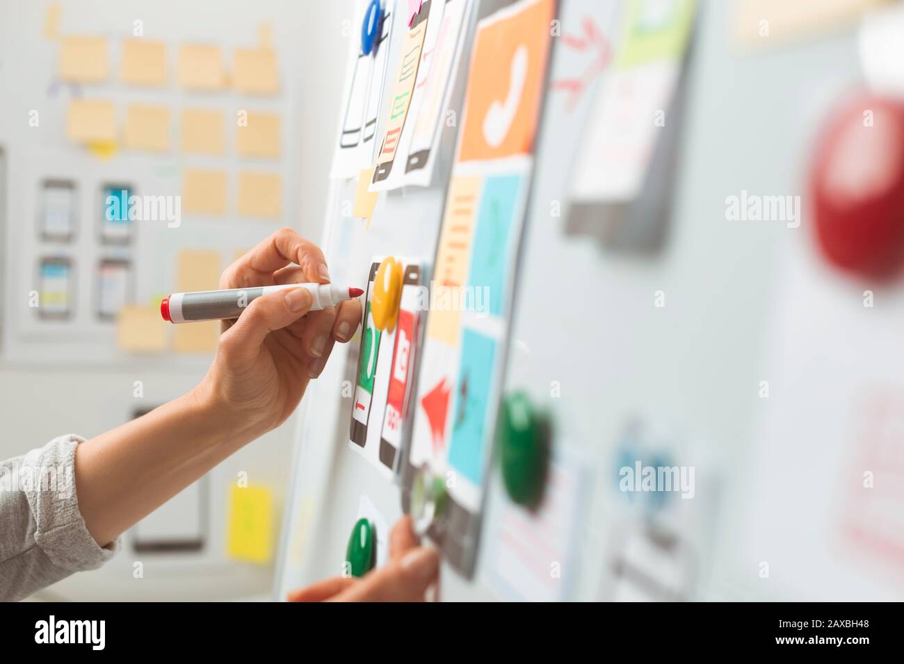 UI website designers are developing a mobile phone application interface. User experience Stock Photo