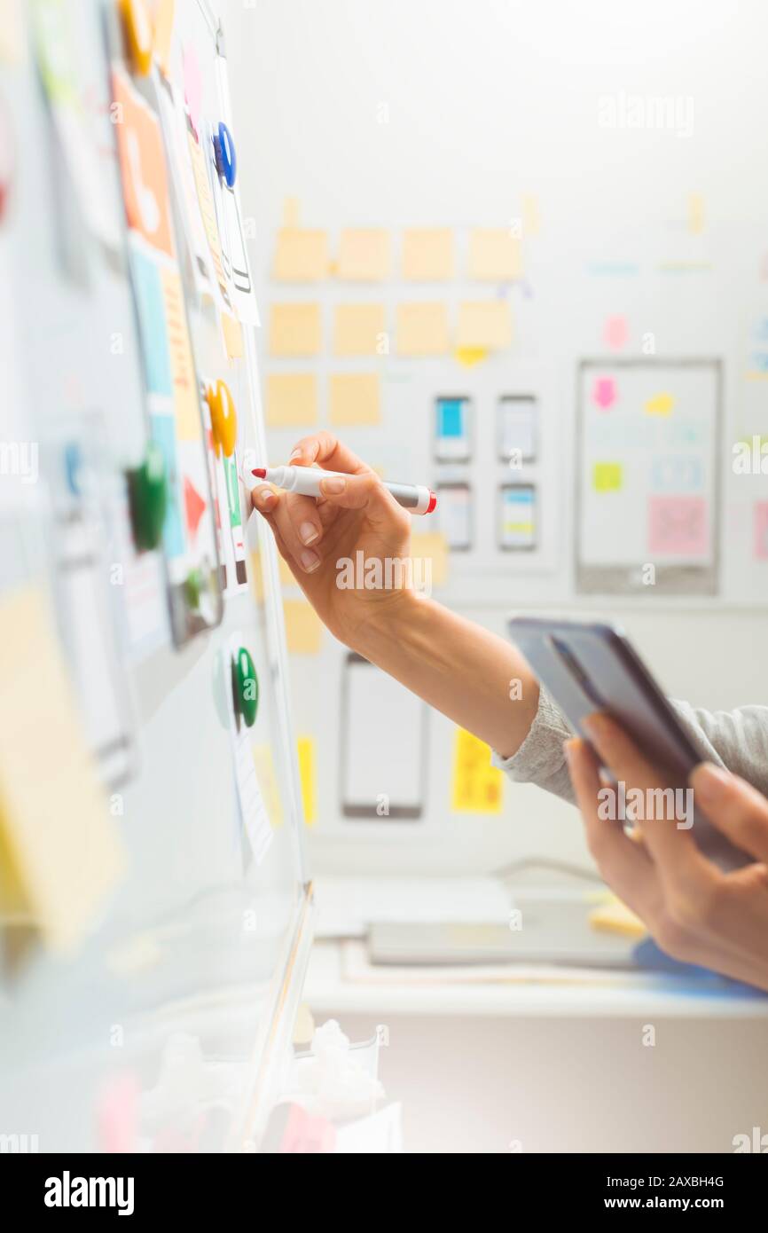 UI website designers are developing a mobile phone application interface. User experience Stock Photo