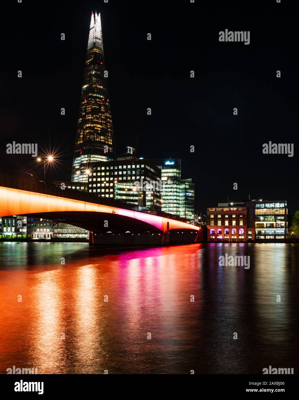 The Shard and London Bridge lit up at night Stock Photo