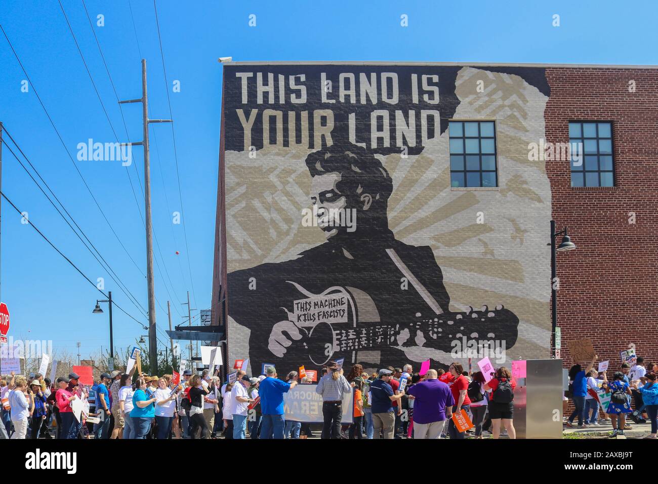 Tulsa OK 3-24-2019 Protestors march down street by Woody Guthrie Museum in Tulsa Stock Photo