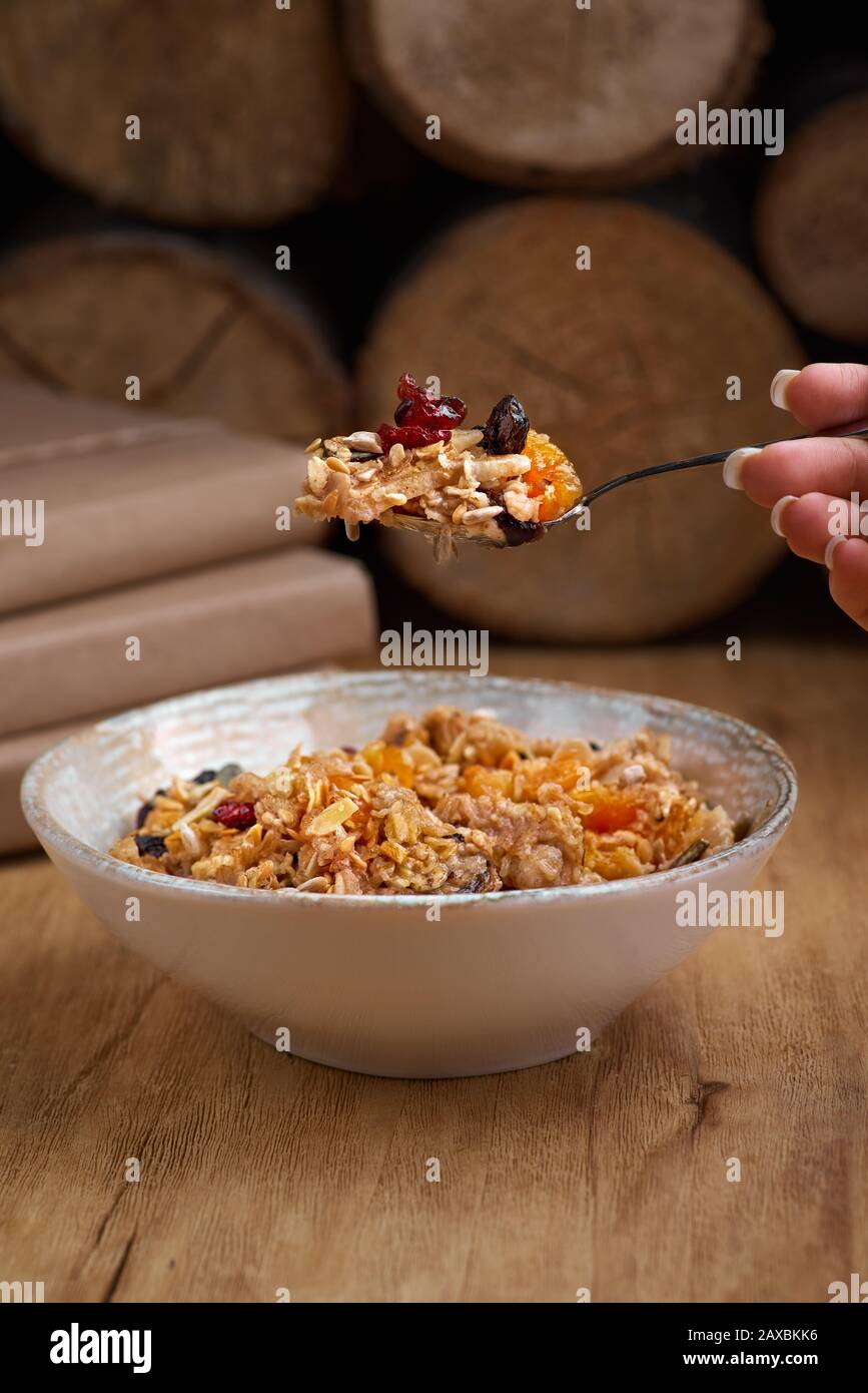 Healthy breakfast concept. Oatmeal, quinoa granola with yogurt, dried fruit, seeds, honey in bowl, copy space. Allergy-friendly, gluten free concept. Stock Photo
