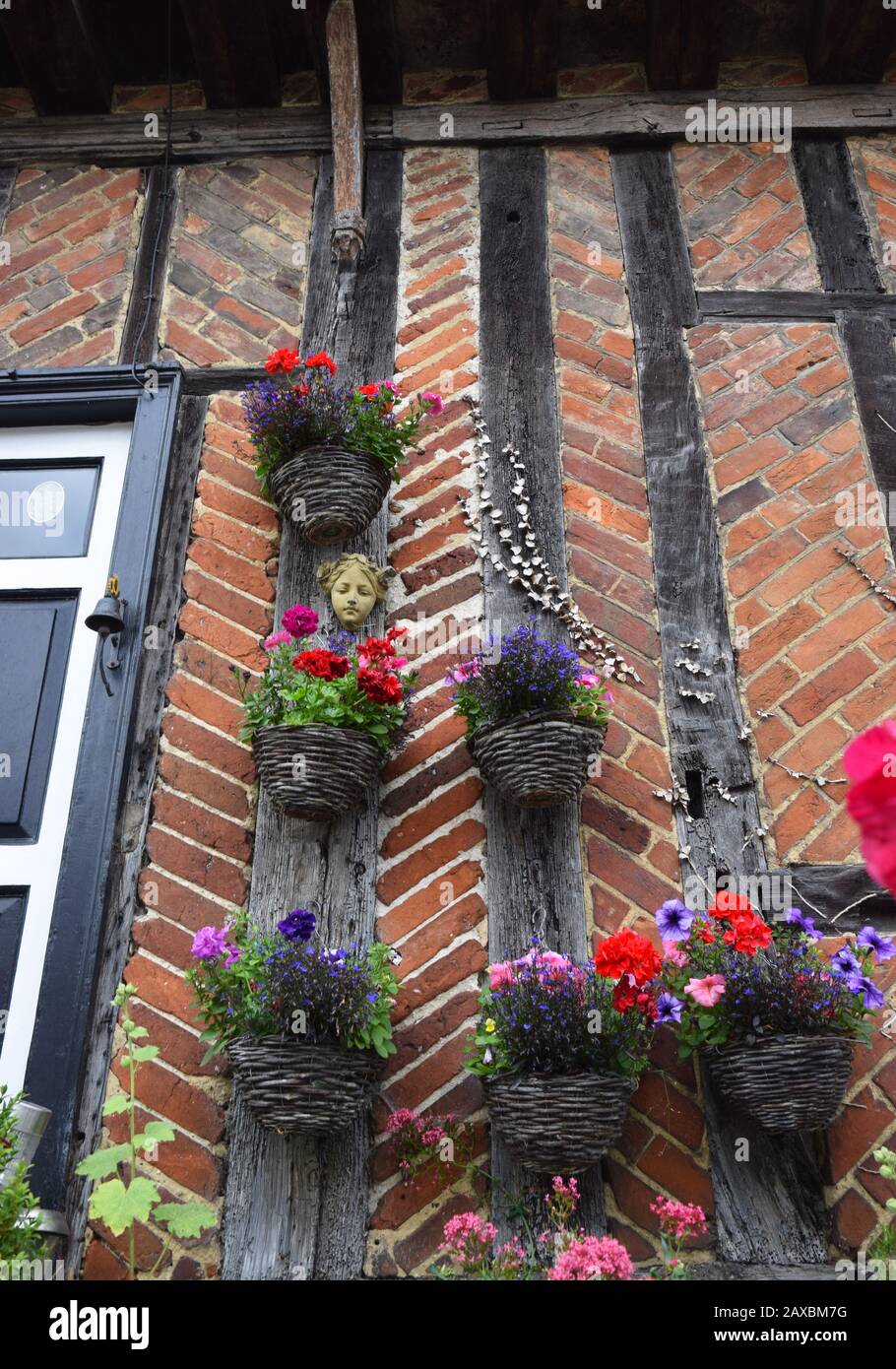 baskets hanging on timber and brick wall Stock Photo Alamy