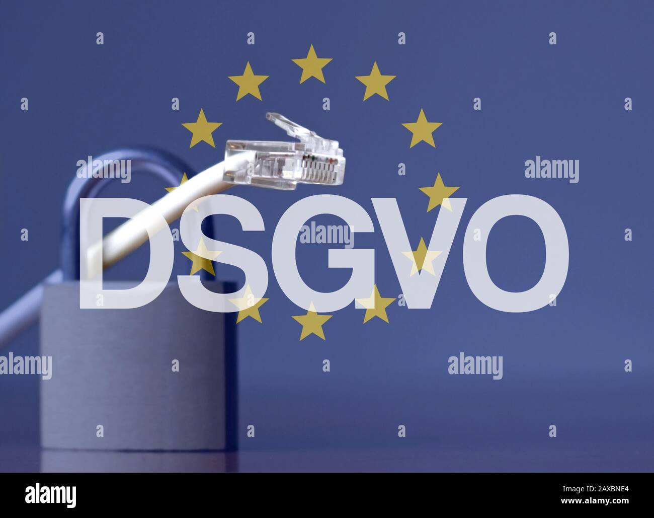 DSGVO acronym against the EU flag and a padlock and ethernet cable Stock Photo