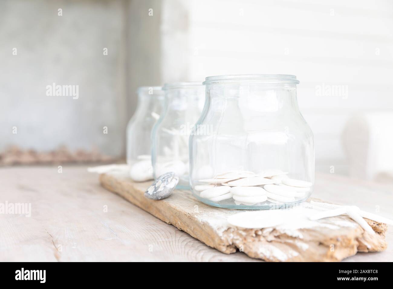 Close up white chocolate melting chips in jar on rustic wood board Stock Photo