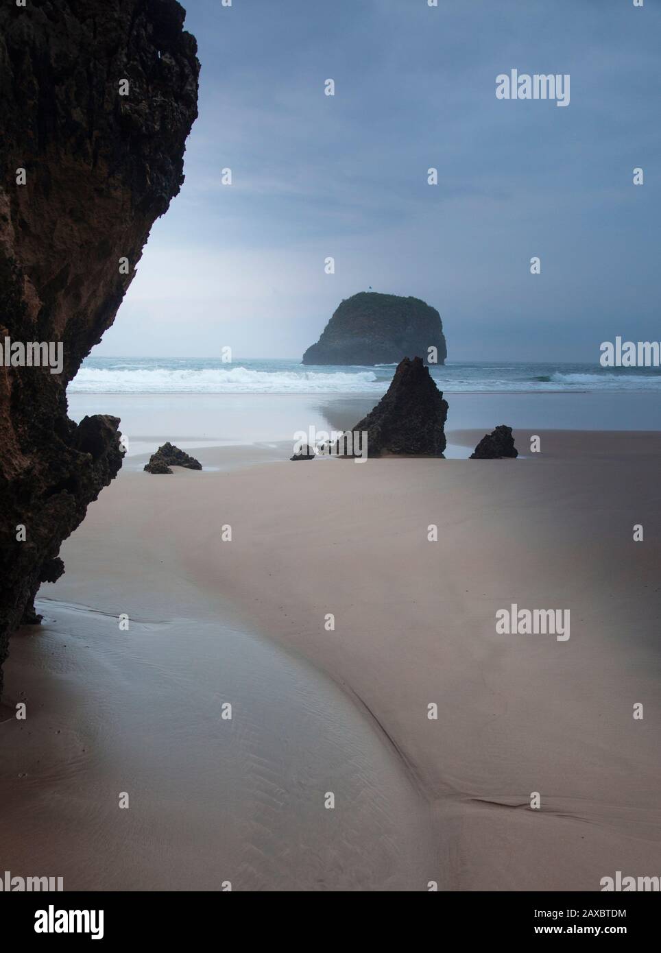 Rocks on tranquil ocean beach Borizo Beach Asturias Spain Stock Photo