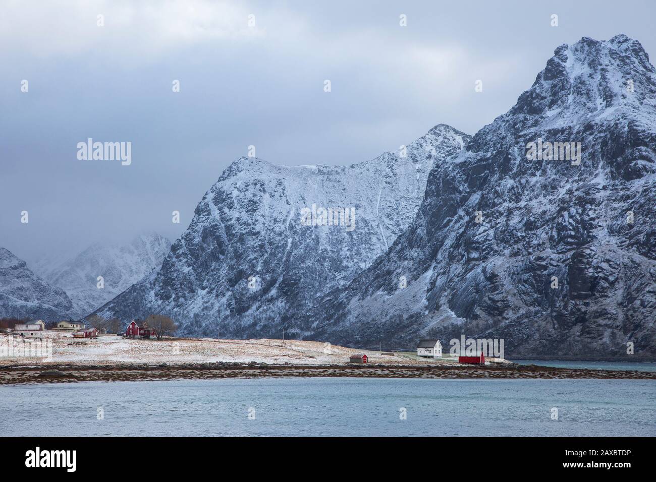 Snow covered mountains above village Flakstadpollen Lofoten Norway Stock Photo