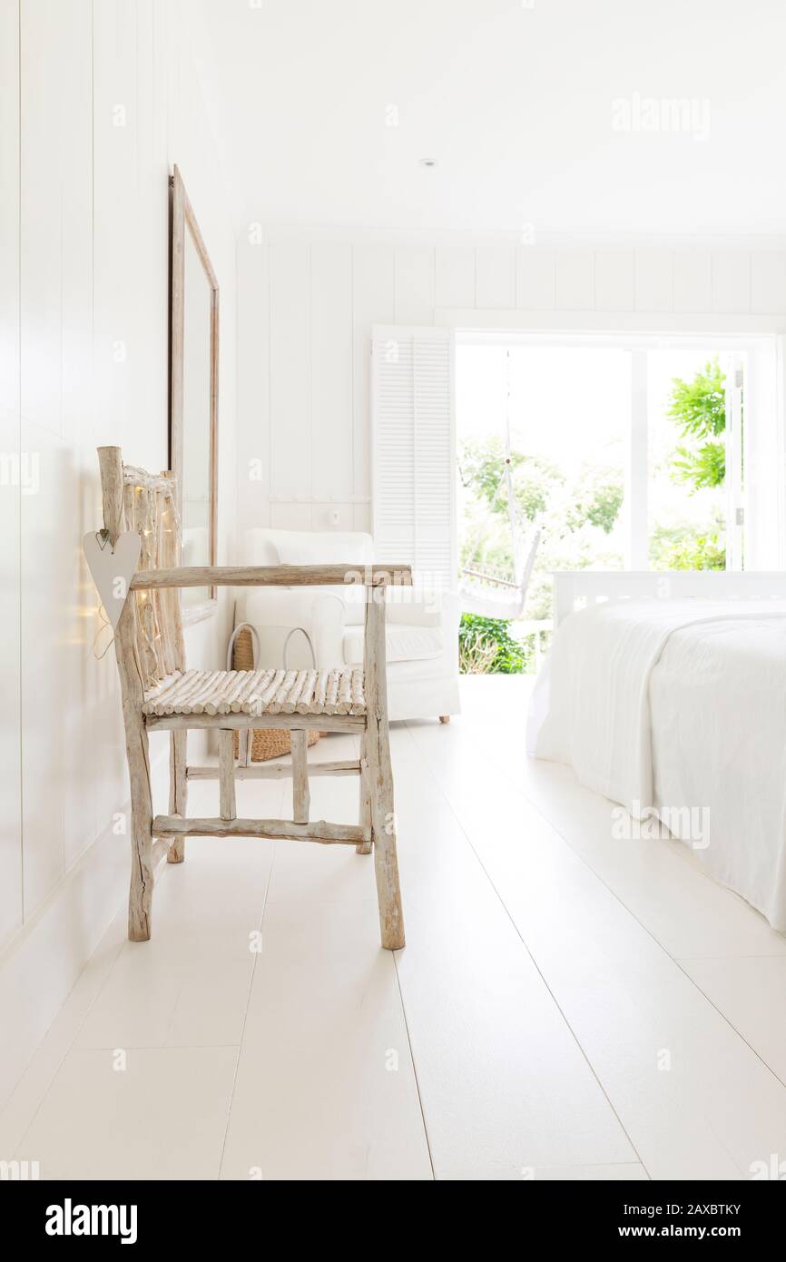 Simple Wood Armchair In White Beach House Bedroom Stock Photo