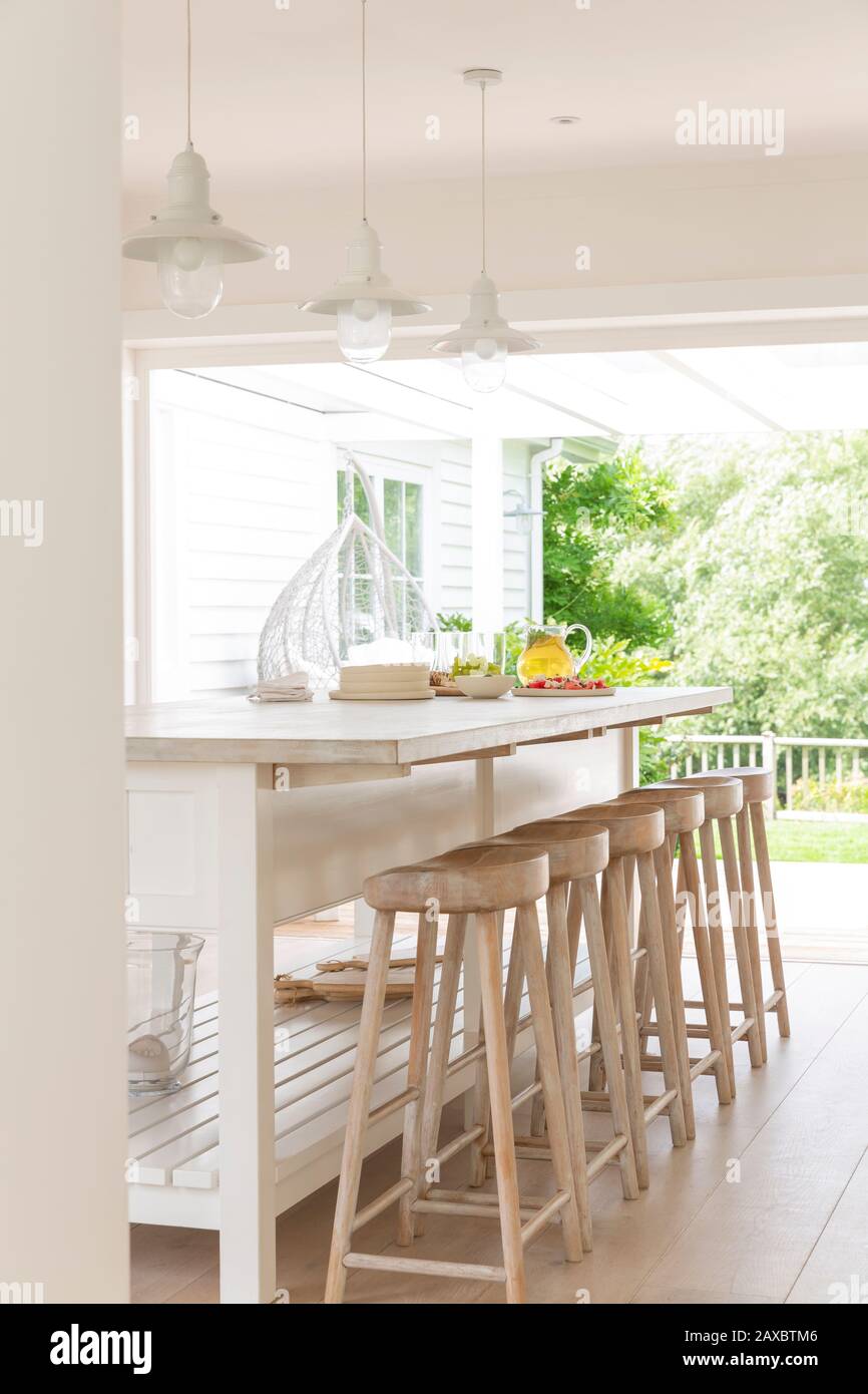 Home showcase kitchen with island and wood barstools Stock Photo Alamy