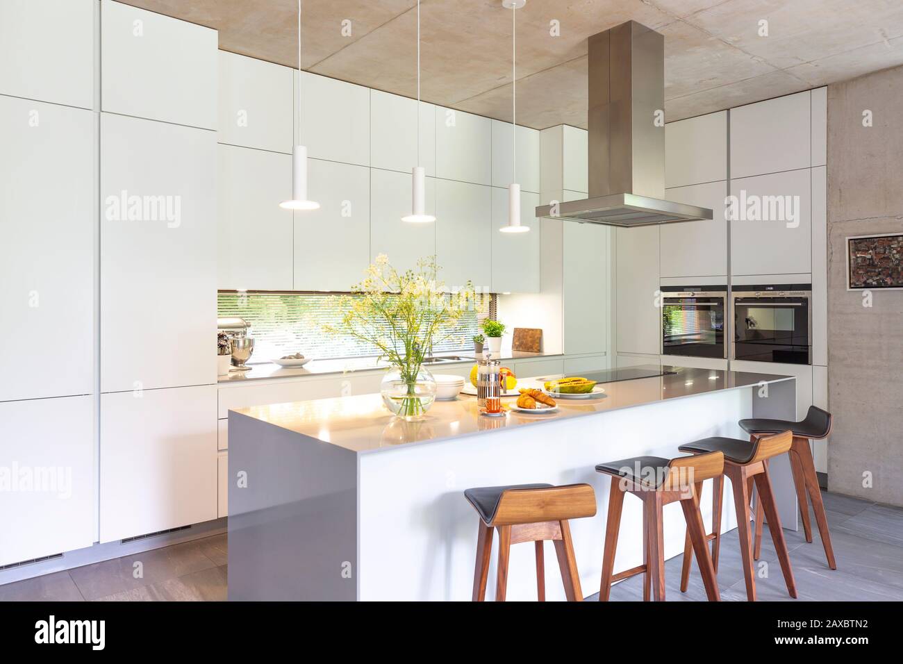 Modern white kitchen with island Stock Photo - Alamy